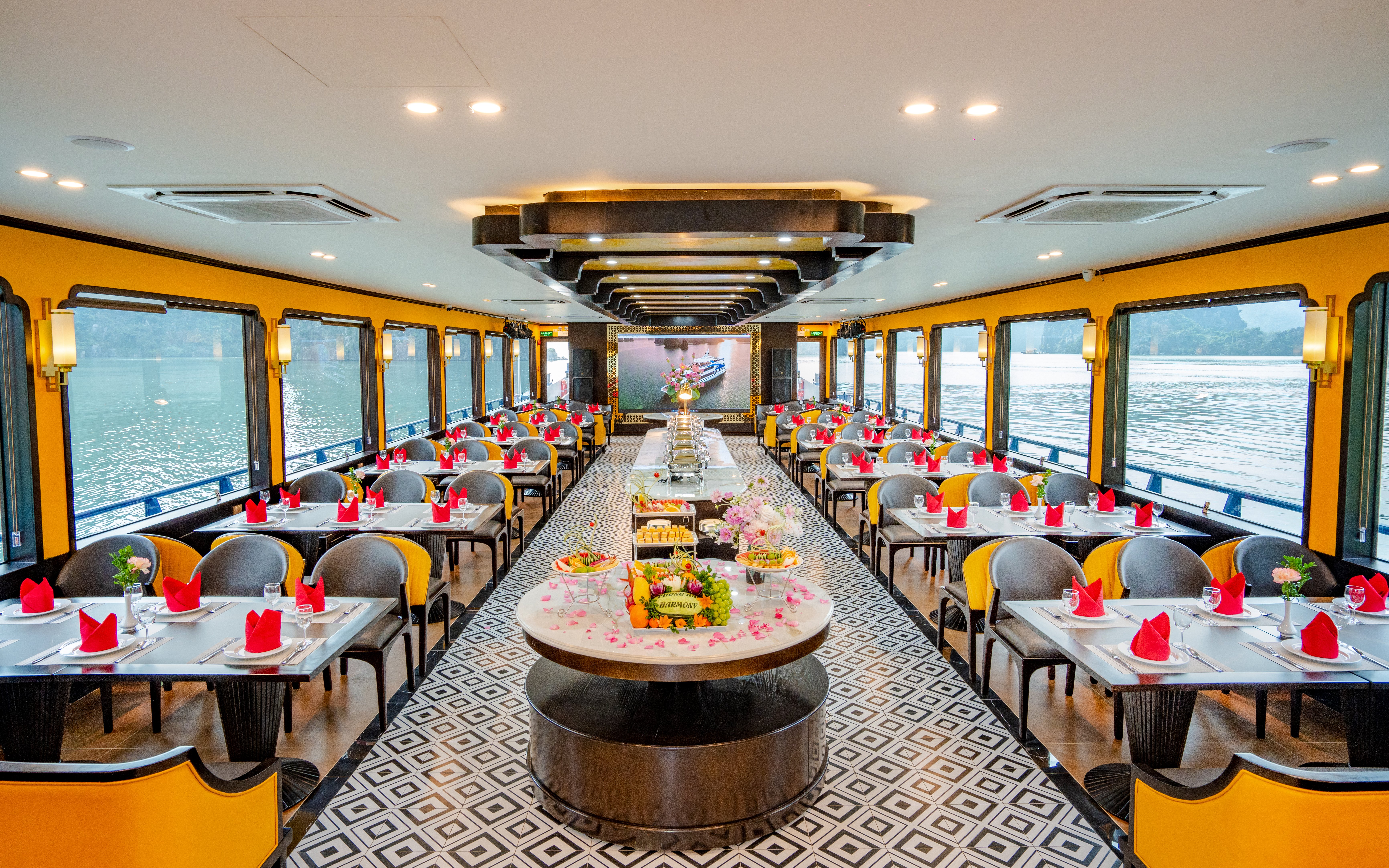 Dining area on Phong Hai Harmony Cruise with set tables and river views.