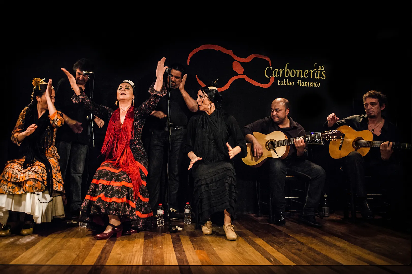 Flamenco dancers and guitarists performing at Tablao LAS CARBONERAS in Madrid.