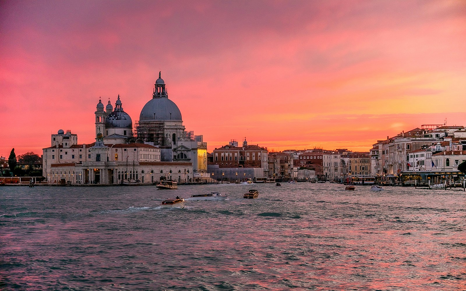Venice Grand Canal at sunset with boats near Santa Maria della Salute.