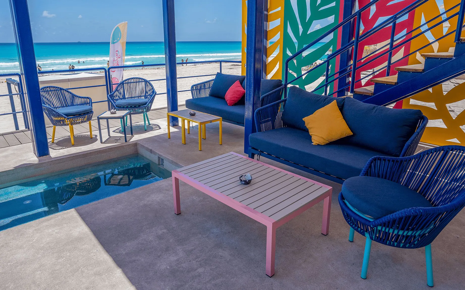 Outdoor seating area at Coco Bongo Beach Party with ocean view and colorful decor.