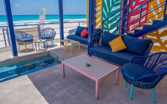 Outdoor seating area at Coco Bongo Beach Party with ocean view and colorful decor.
