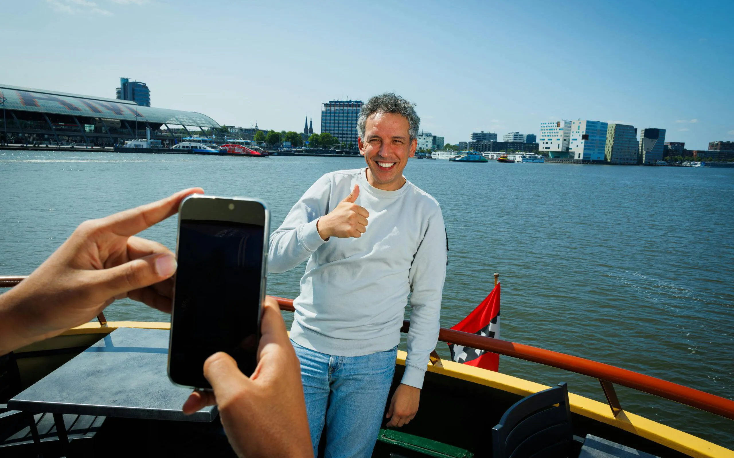 Man giving thumbs up on a boat during Dutch Pancake cruise in Amsterdam.