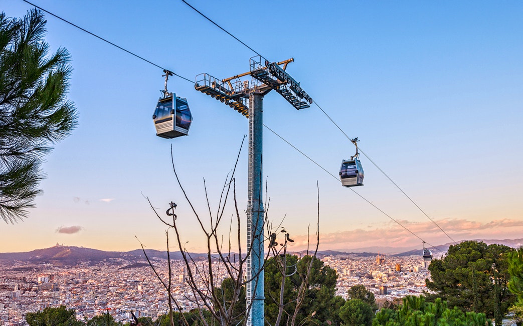 Montjuic cable car over Barcelona cityscape at evening, Spain.