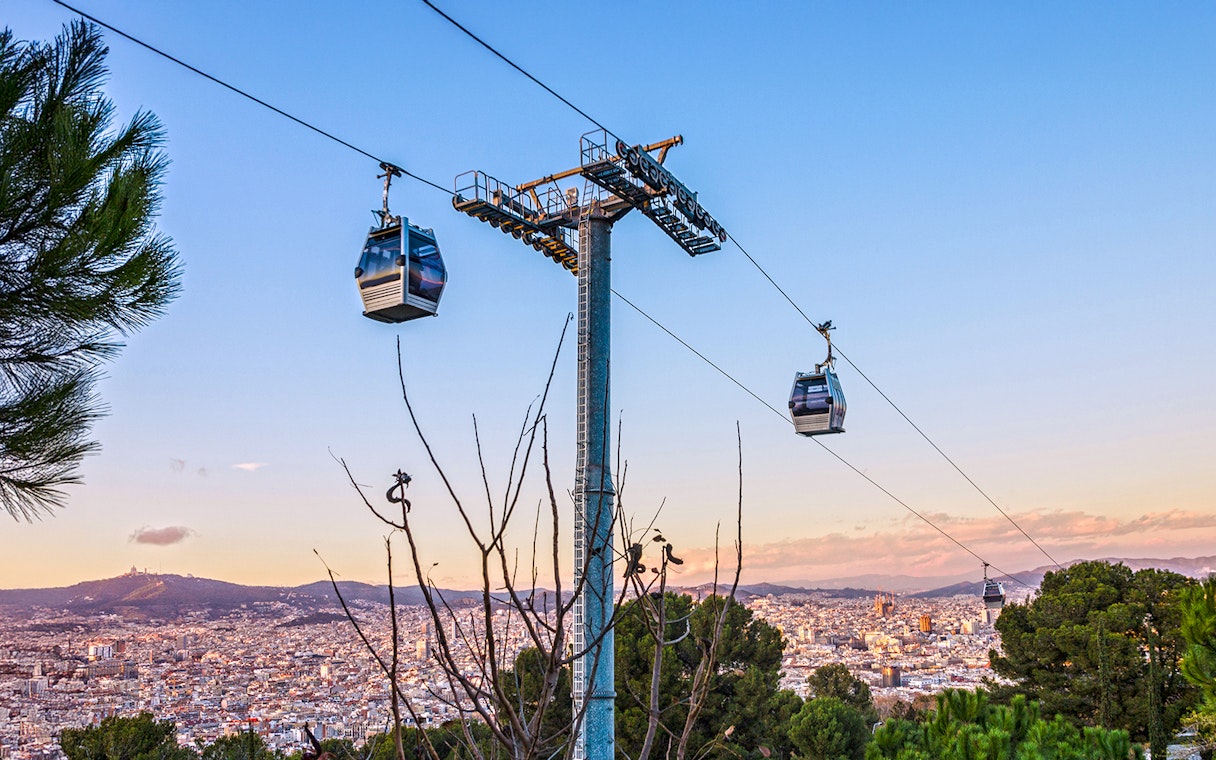 Montjuic cable car over Barcelona cityscape at evening, Spain.