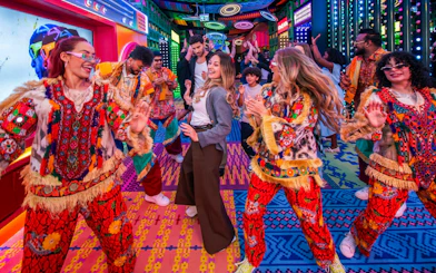 Dancers in vibrant costumes at Electric Carnival, House of Hype.