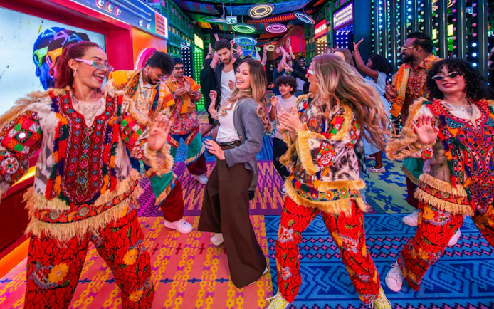 Dancers in vibrant costumes at Electric Carnival, House of Hype.