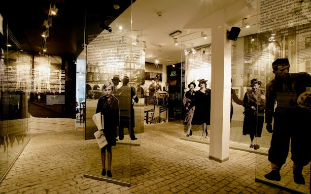 Exhibit at Schindler's Factory Museum in Krakow, featuring historical photographs and displays.