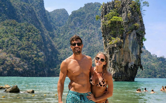 Couple enjoying James Bond Island tour with limestone cliffs in Phuket.