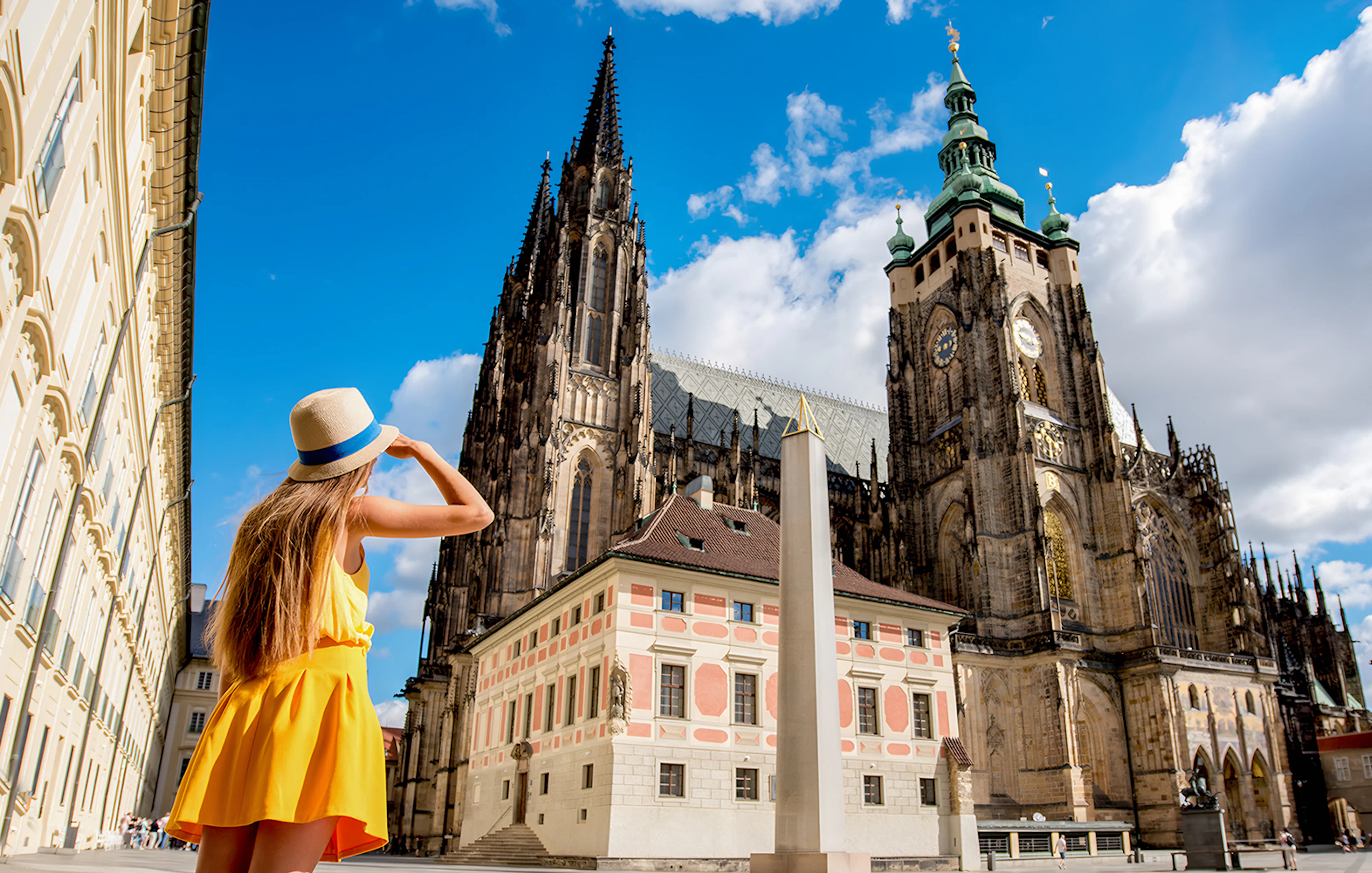 Woman admiring St. Vitus Cathedral in Prague Castle complex, Czech Republic.