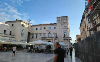 Zadar city square with historic buildings and outdoor cafes, part of the self-guided exploration game.