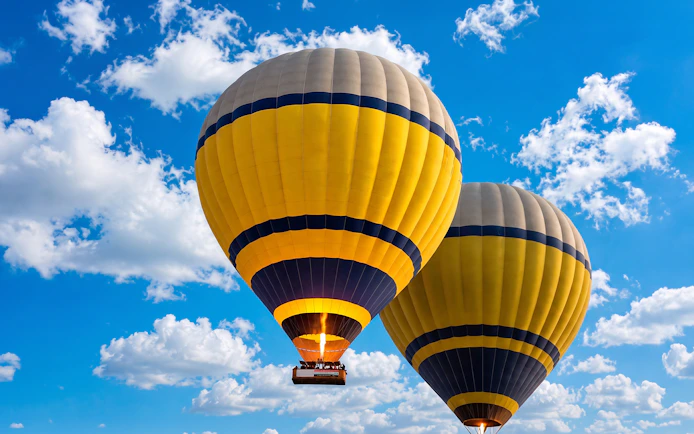 Hot air balloons ascending during sunrise in Luxor, Egypt.