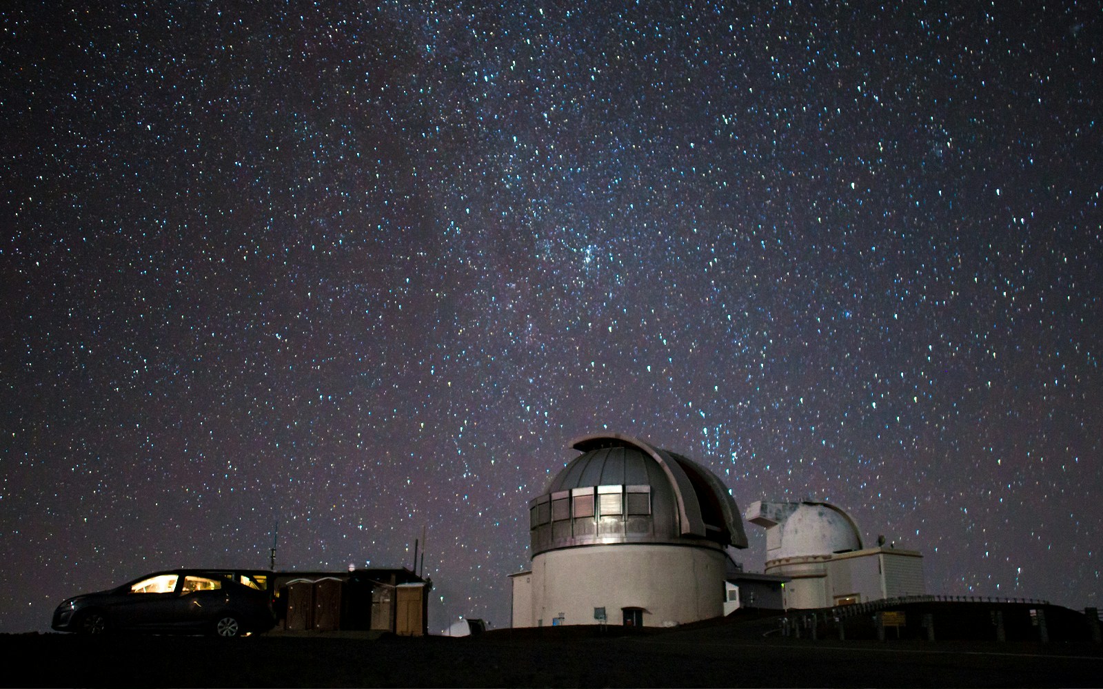 Mauna Kea observatory under a starry night sky, ideal for stargazing tours.