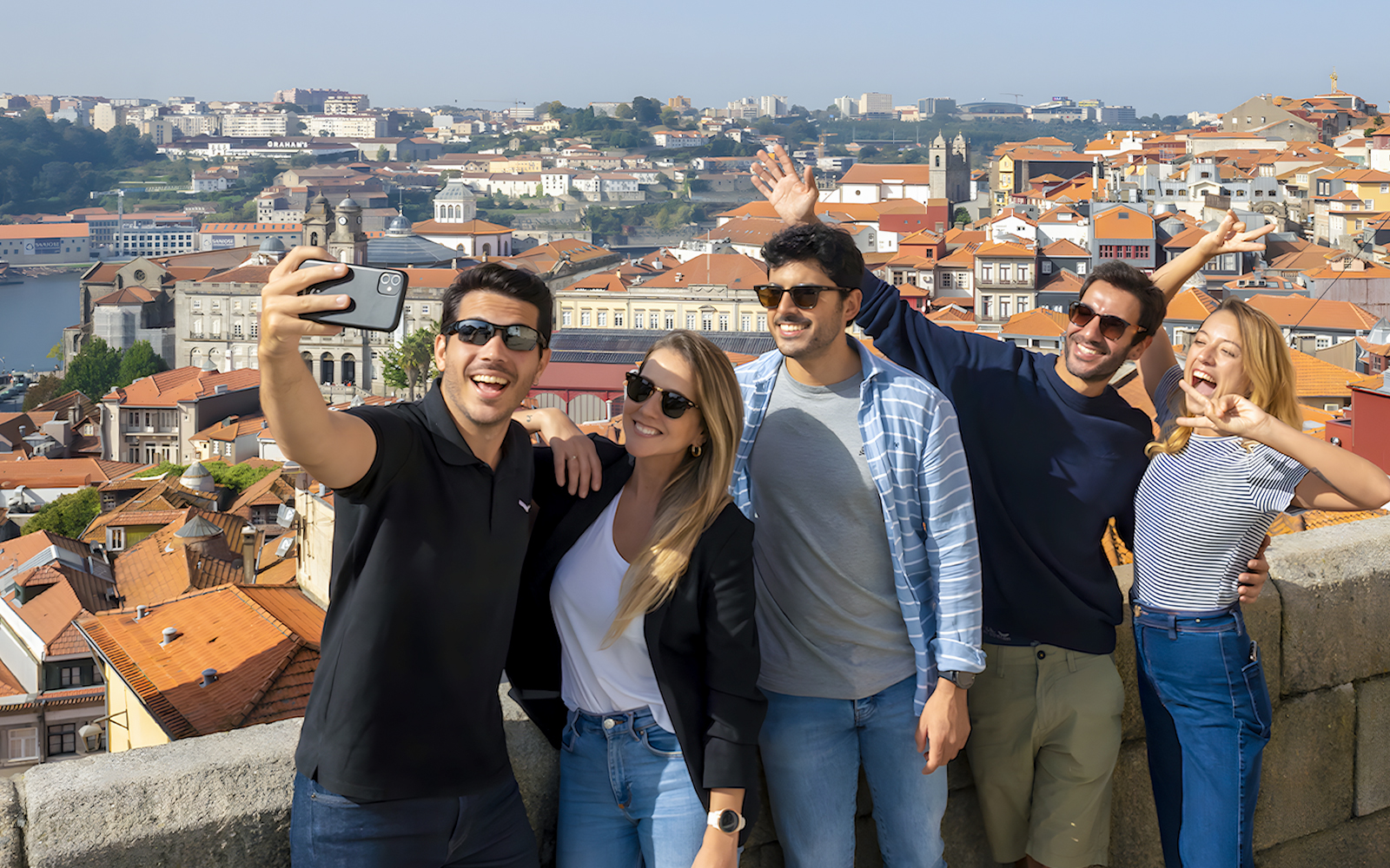 Tourists taking a selfie with a guide overlooking Porto's cityscape during a walking tour.