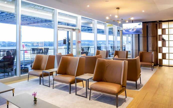 Primeclass Lounge seating area with large windows at Zurich Airport Terminal E.