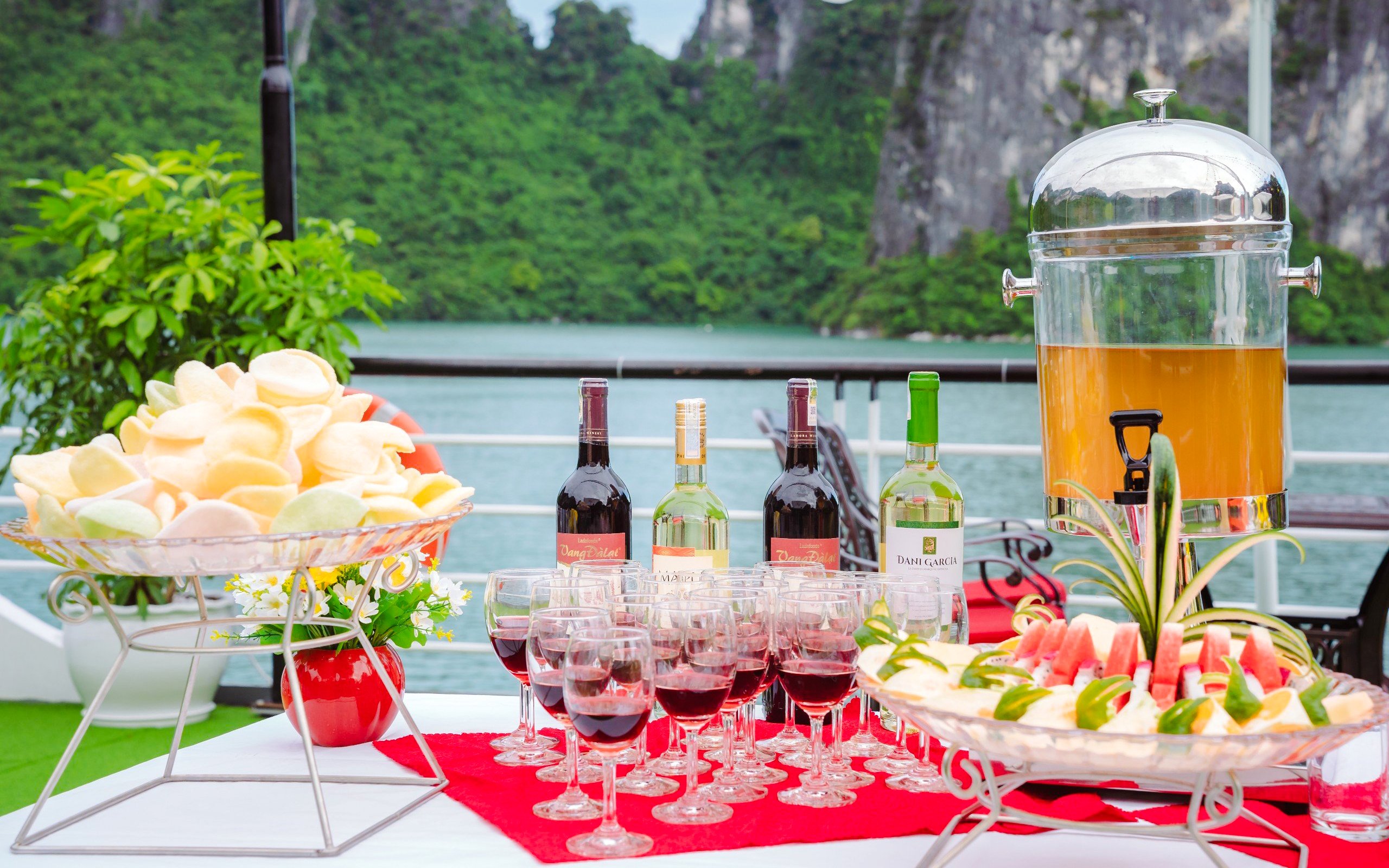 Wine and refreshments setup on Apollo Cruise Ha Long Bay with scenic view.