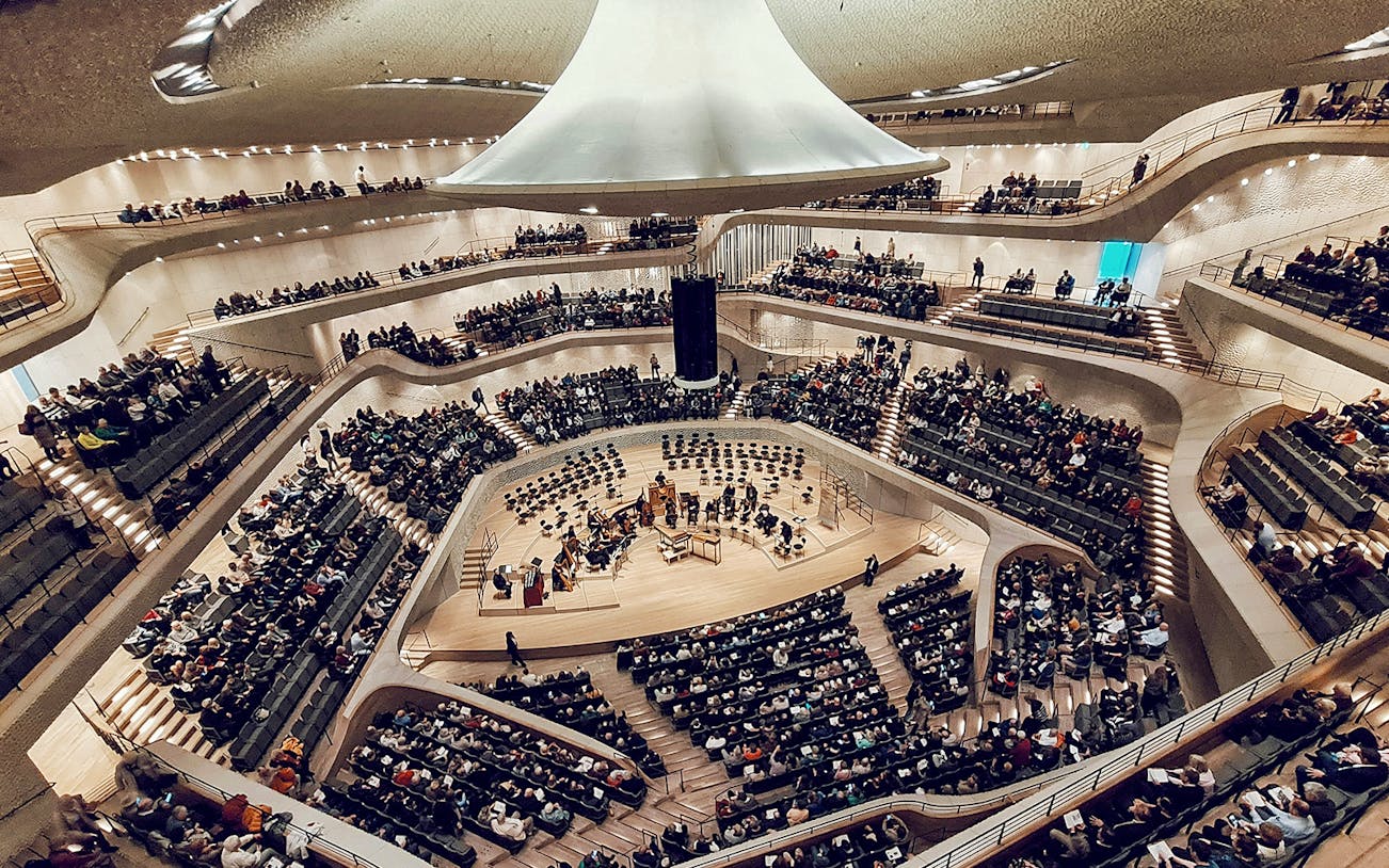 Interior view of Elbphilharmonie Concert Hall with audience and stage setup.