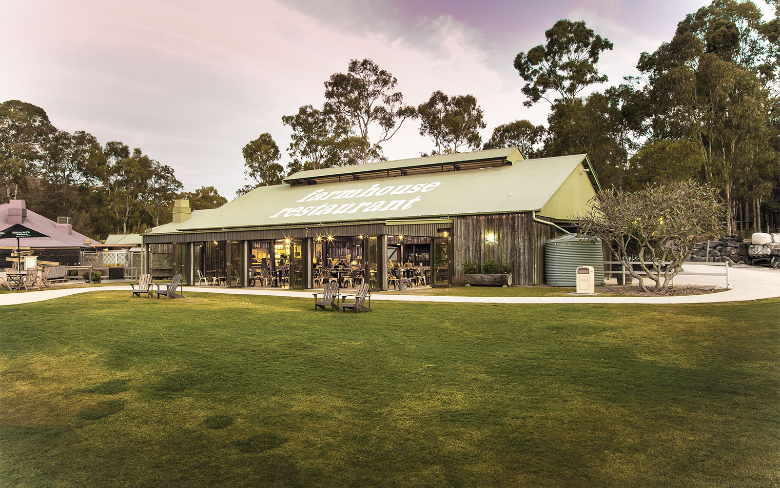 Farmhouse Restaurant at Paradise Country with outdoor seating and surrounding trees.