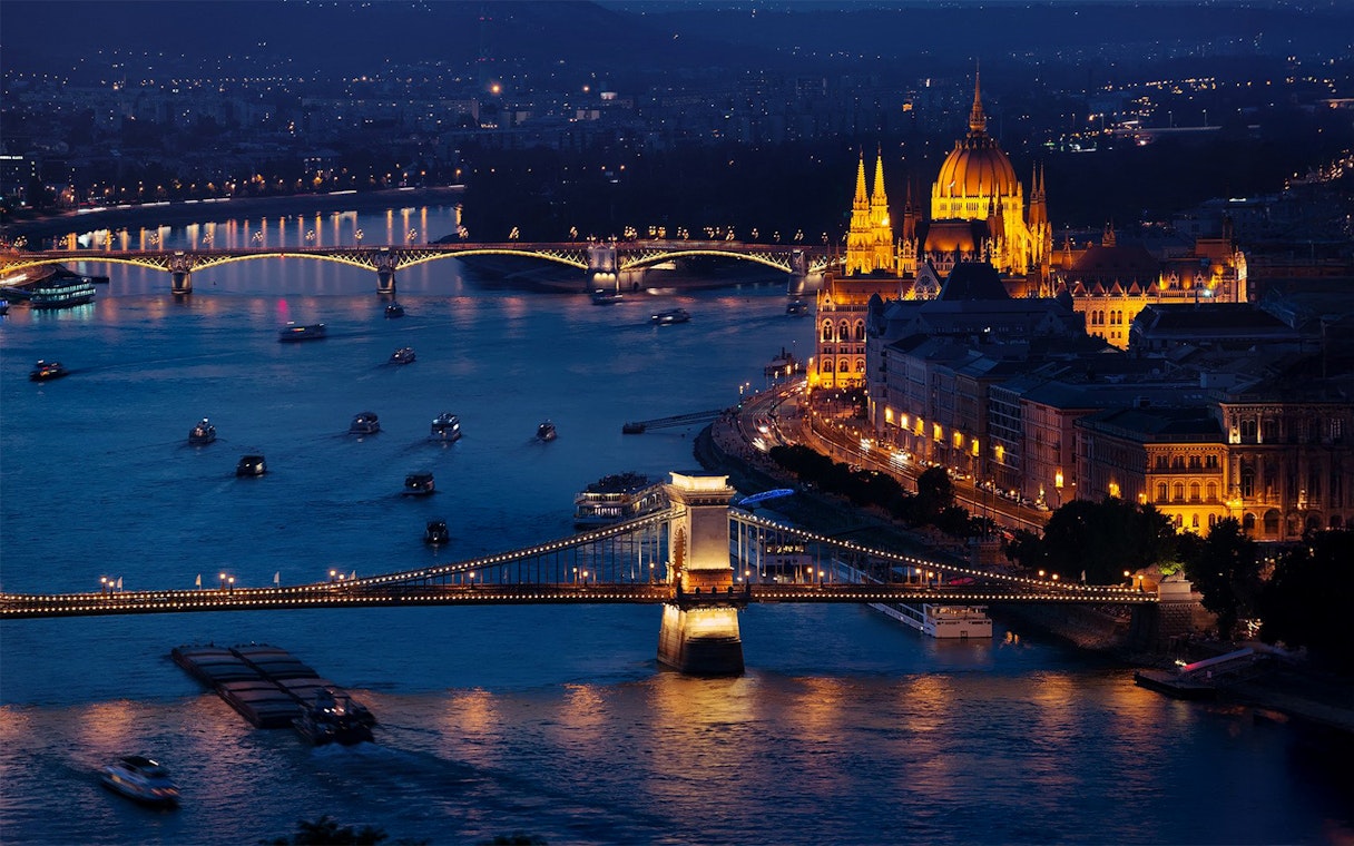 Budapest Chain Bridge and Castle illuminated at night over the Danube River.