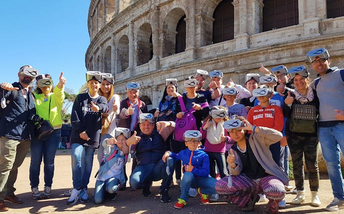 Group wearing VR headsets outside the Colosseum in Rome.