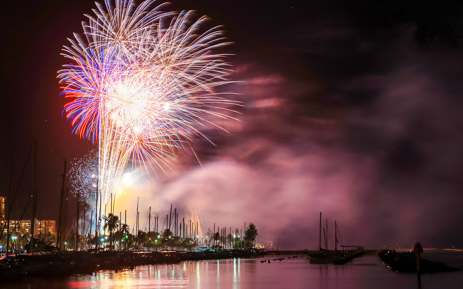 Fireworks illuminating the night sky over Waikiki Beach, Hawaii.