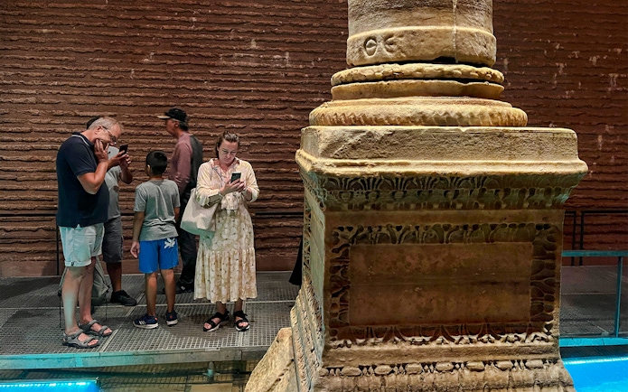 Visitors observing ancient columns at Basilica Cistern, Istanbul.