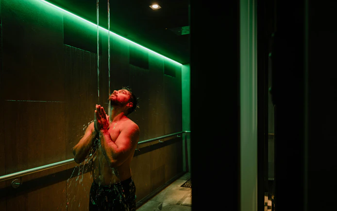 Man enjoying water shower at Wai Ariki Hot Springs & Spa, Rotorua.