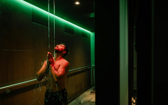 Man enjoying water shower at Wai Ariki Hot Springs & Spa, Rotorua.