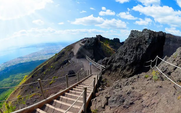 Pathway along Mount Vesuvius with view of Naples coastline.