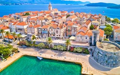 Aerial view of historic Korcula town with stone buildings and Adriatic Sea, Croatia.