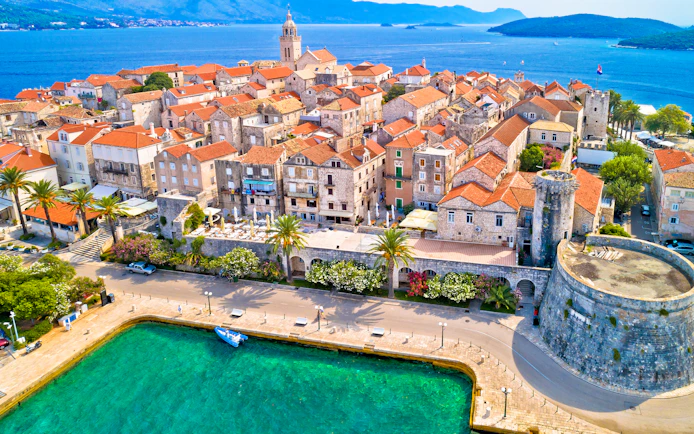 Aerial view of historic Korcula town with stone buildings and Adriatic Sea, Croatia.
