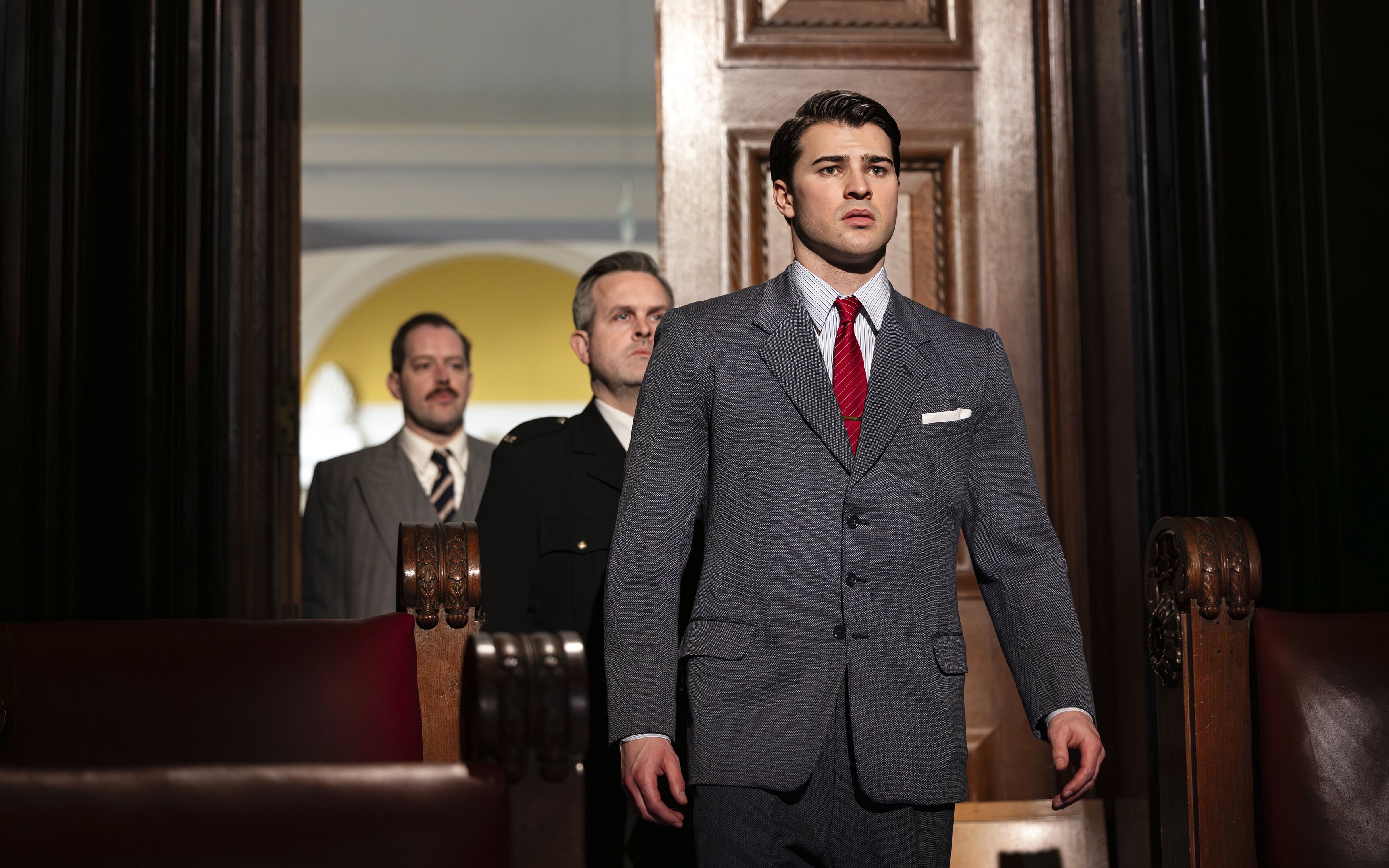 Courtroom scene from "Witness for the Prosecution" performance with actors in suits.