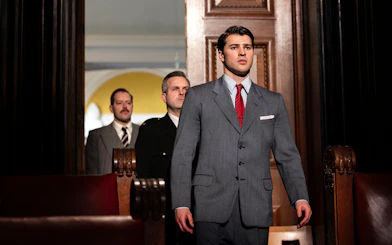Courtroom scene from "Witness for the Prosecution" performance with actors in suits.
