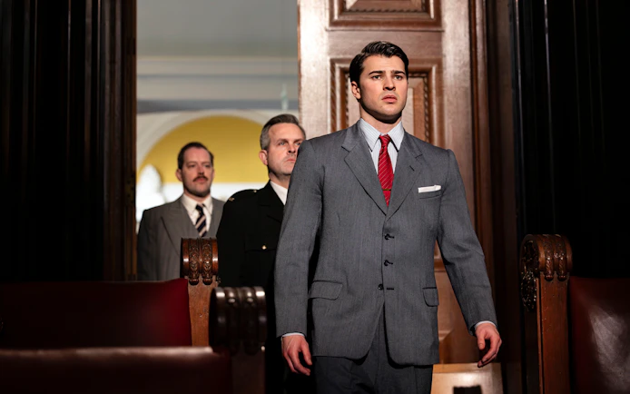 Courtroom scene from "Witness for the Prosecution" performance with actors in suits.
