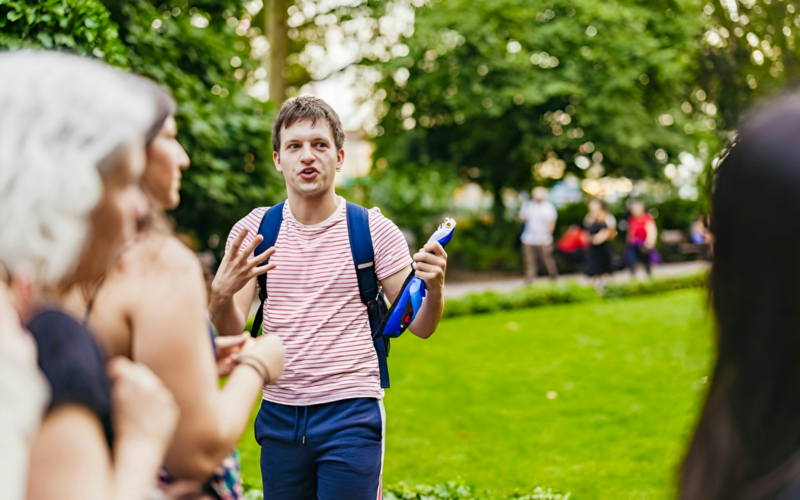 Tour guide leading Harry Potter film locations tour in London park.