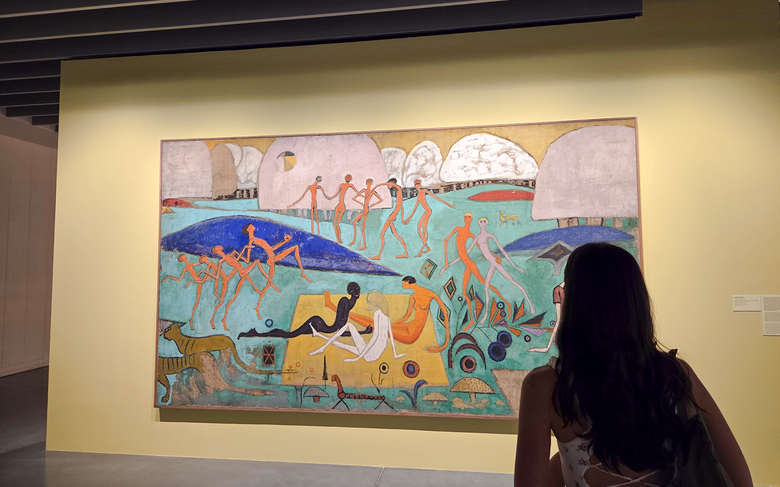 Exhibition visitor viewing colorful abstract painting at Centre Pompidou Malaga.