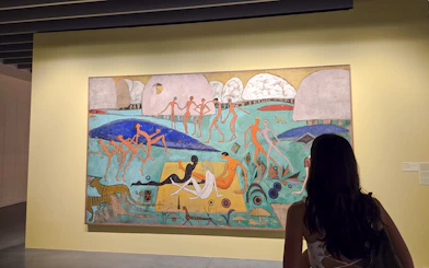 Exhibition visitor viewing colorful abstract painting at Centre Pompidou Malaga.