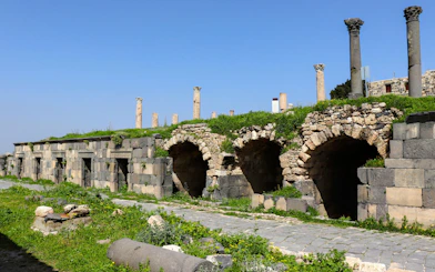Ancient Roman ruins with stone arches and columns in Umm Qais, Irbid, Jordan.