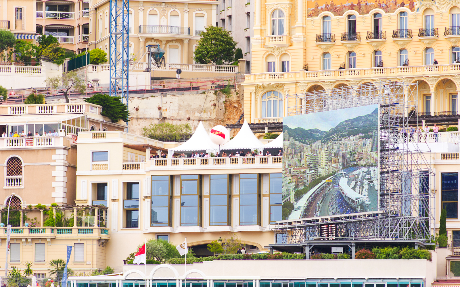 Monaco cityscape with Formula 1 track view on large screen during walking tour.