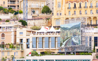 Monaco cityscape with Formula 1 track view on large screen during walking tour.