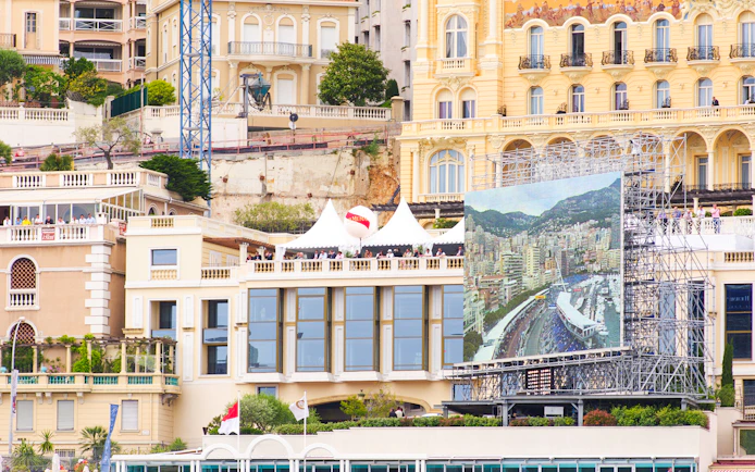 Monaco cityscape with Formula 1 track view on large screen during walking tour.