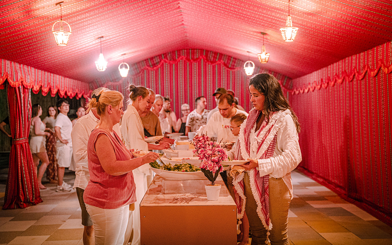 Guests serving themselves dinner at Abu Dhabi desert safari buffet.
