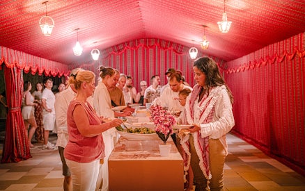 Guests serving themselves dinner at Abu Dhabi desert safari buffet.