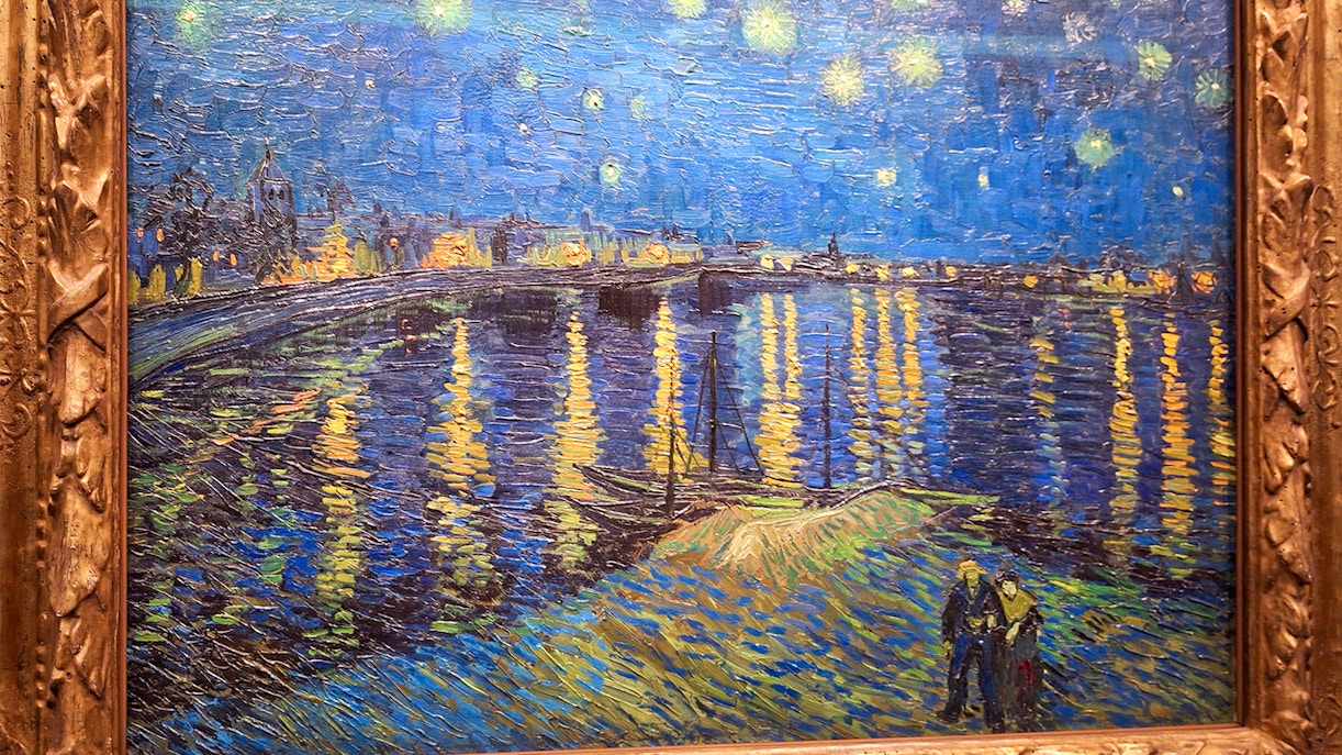Orsay Museum painting of Van Gogh's "Starry Night Over the Rhône" with stars and reflections.
