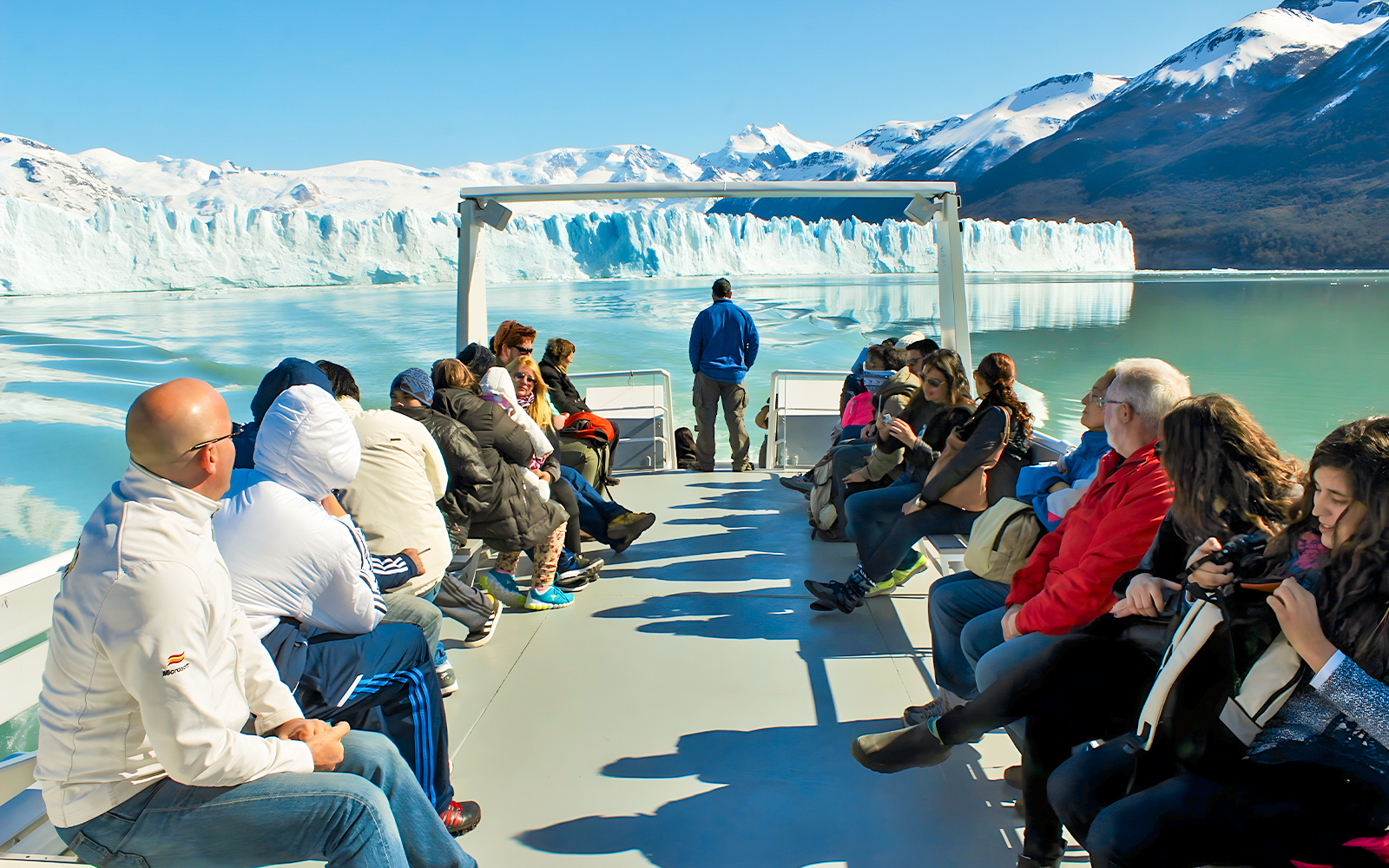 Tourists on Perito Moreno Cruise deck viewing glacier in Argentina.