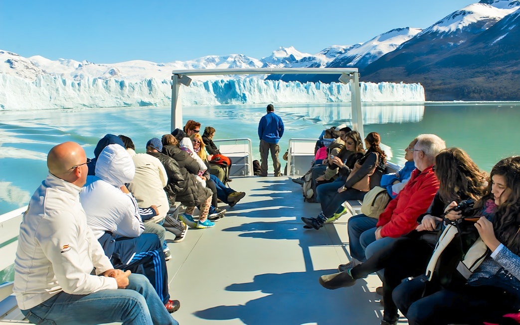 Tourists on Perito Moreno Cruise deck viewing glacier in Argentina.