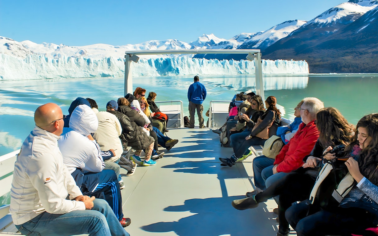 Tourists on Perito Moreno Cruise deck viewing glacier in Argentina.