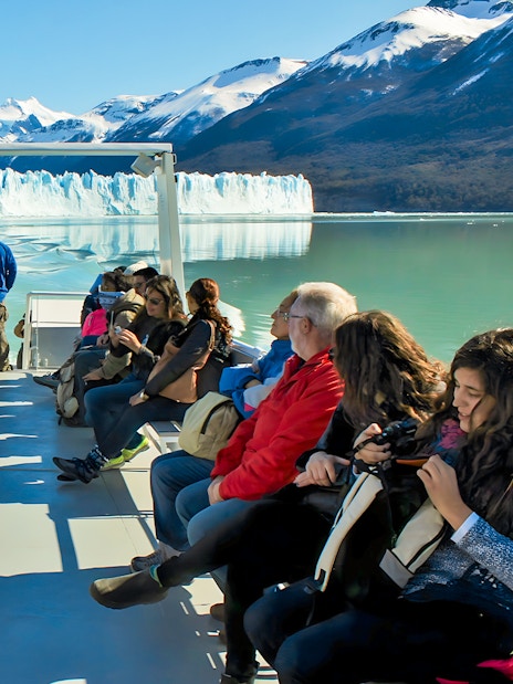 Tourists on Perito Moreno Cruise deck viewing glacier in Argentina.
