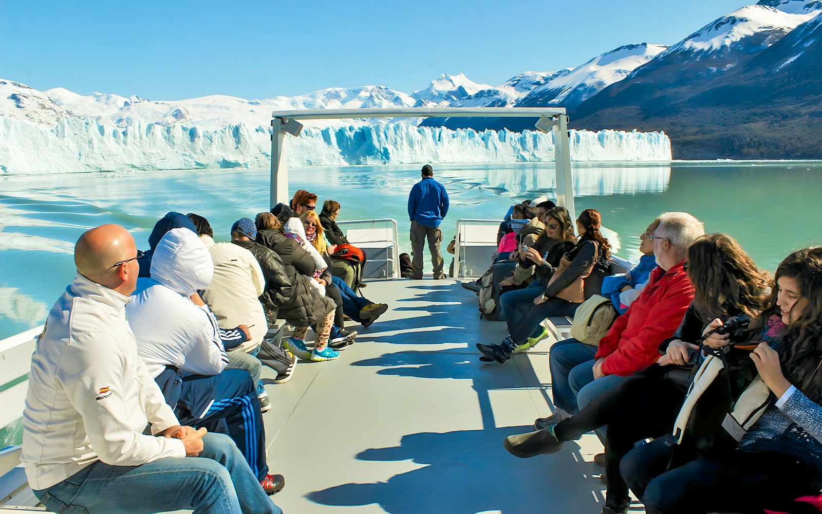 Tourists on Perito Moreno Cruise deck viewing glacier in Argentina.