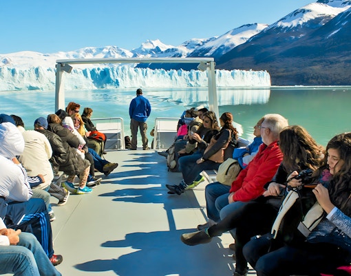 Tourists on Perito Moreno Cruise deck viewing glacier in Argentina.