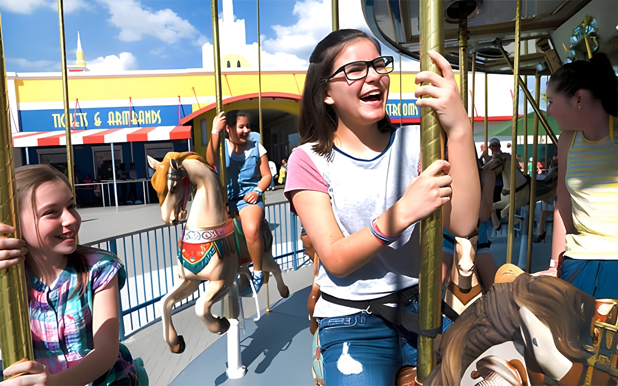 Girls riding a carousel at Fun Spot America Theme Parks, Orlando.